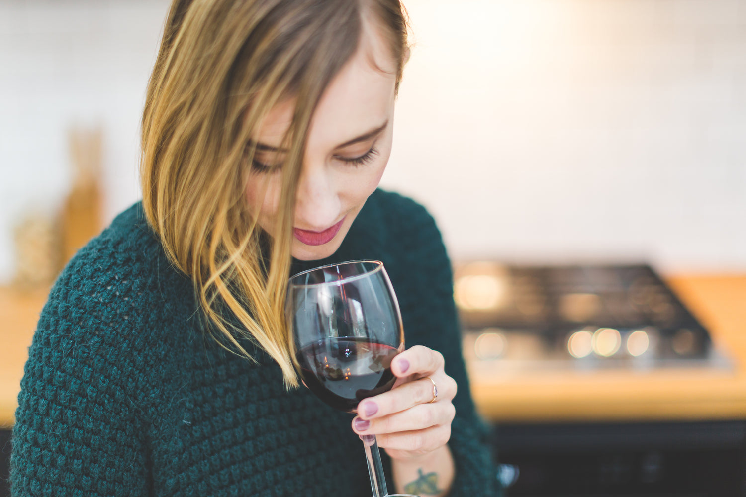 Woman enjoying Antoniadis Estate Wine, a premium Napa Valley experience.